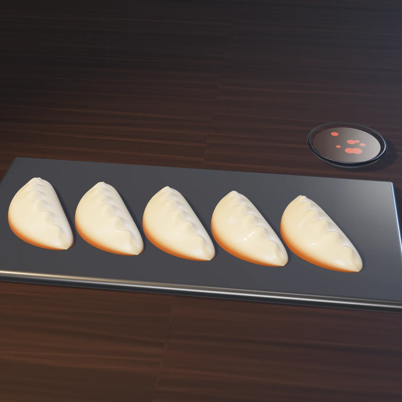 Five pan-fried gyoza with golden, crisp edges on a slate plate next to a dish of chili-oil dipping sauce